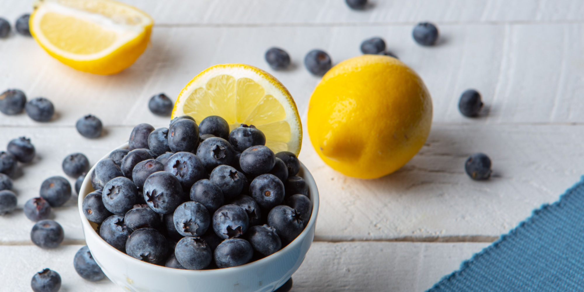 fresh Lemons and blueberries on a farmhouse background